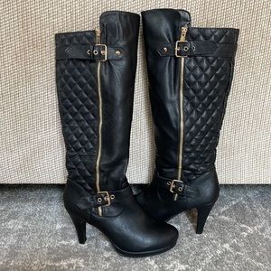 Black quilted knee high boot with gold zipper accents